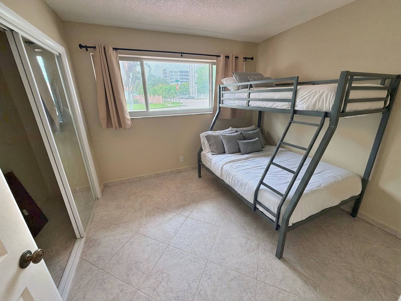 Bunk bedroom with a full bed below and a single above, good for kids