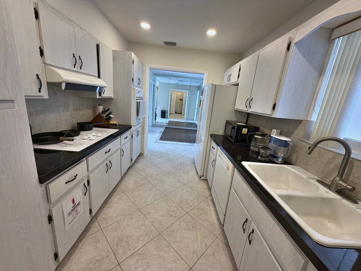 Full kitchen with cooktop, oven and dishwasher in the Hallandale Beach vacation home