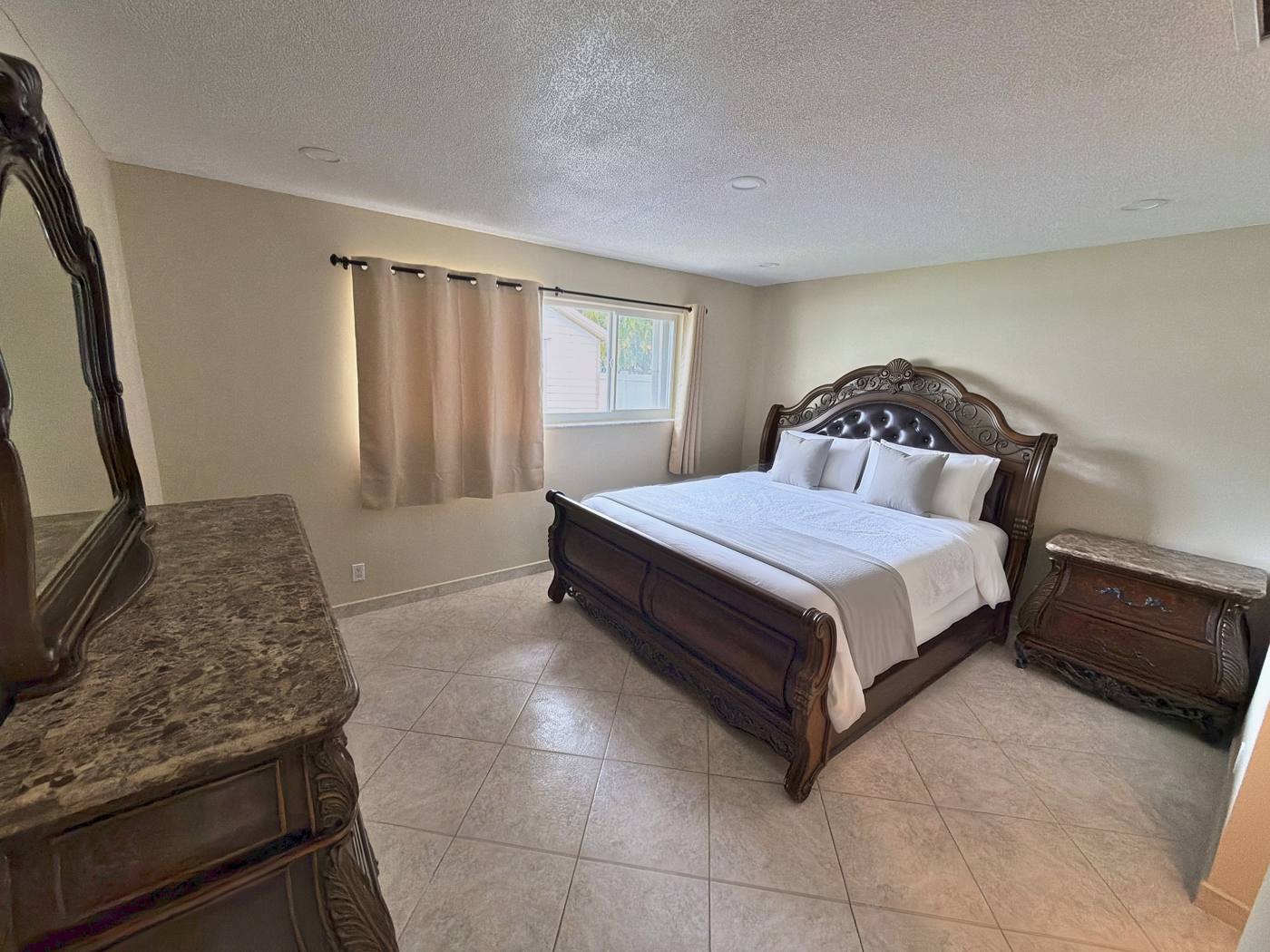 Master bedroom with king bed and ensuite bathroom in the Hallandale Beach vacation rental